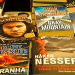 A collection of bestselling thriller novels prominently displayed in a bookstore setting.