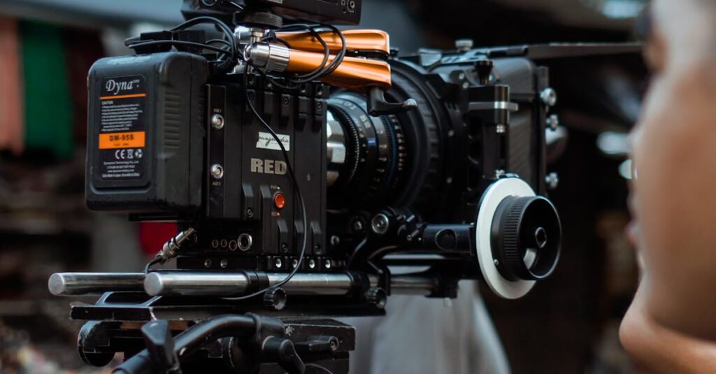 Close-up of professional video camera and crew on an outdoor film set.