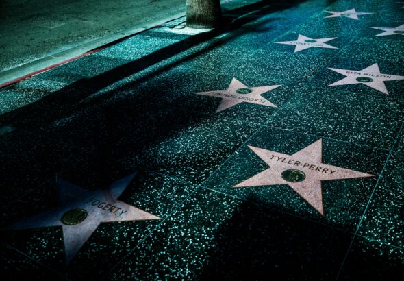 Night view of Hollywood Walk of Fame stars showcasing celebrity names and iconic design.