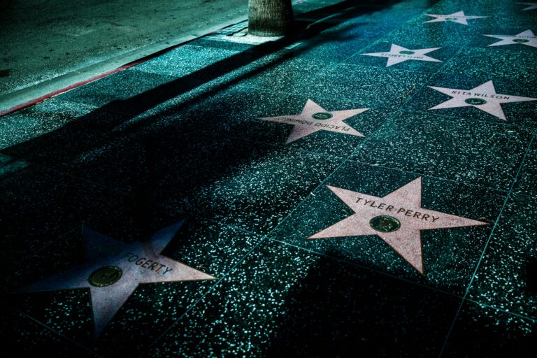 Night view of Hollywood Walk of Fame stars showcasing celebrity names and iconic design.