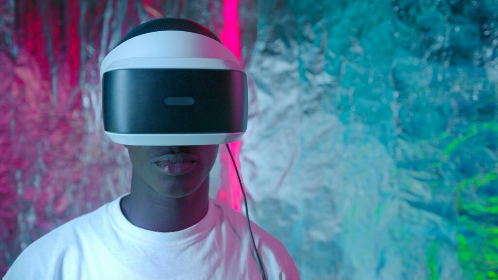Teen enjoying virtual reality experience with vibrant neon lights.